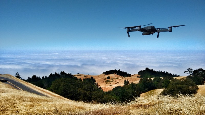 Drone flying over agricultural fields for crop monitoring